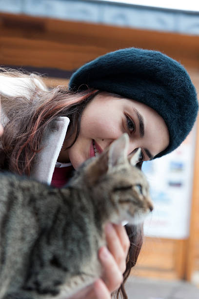 istock Female Turkish Student Playing with Cat while Waiting Ferryboat, Istanbul 523785061