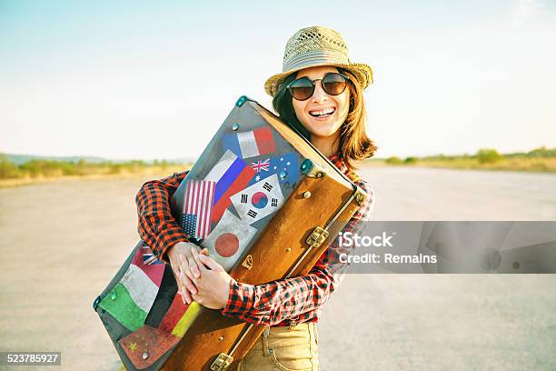 Woman Embraces A Suitcase With Stamps Flags Stock Photo - Download Image Now - Label, Suitcase, Adult