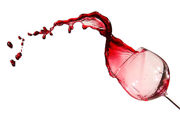Red Wine Spill A glass of red wine tipping over spilling stock pictures, royalty-free photos & images