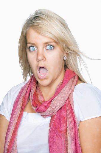 Young woman looking surprised, jaw-dropping