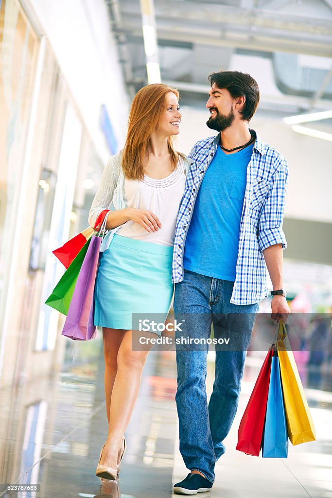 Couple in the mall Happy young couple in casual during shopping in the mall Adult Stock Photo