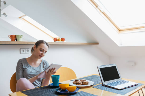 istock Woman looking at digital tablet during breakfast. 523787955