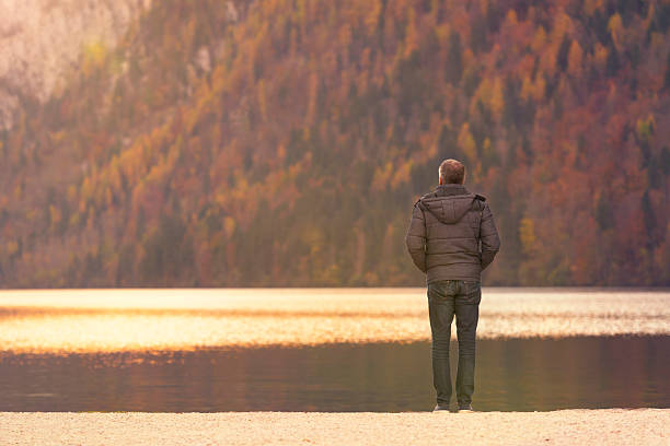 istock Sunset on the lake with a lonely man 523788129