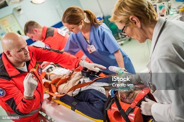 Paramedics And Doctors In Emergency Room Stock Photo - Download Image Now - Emergency Room, Accidents and Disasters, Emergency Sign