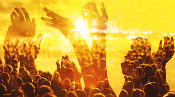 istock cheering crowd at concert, double exposure with rock festival hands 523820088
