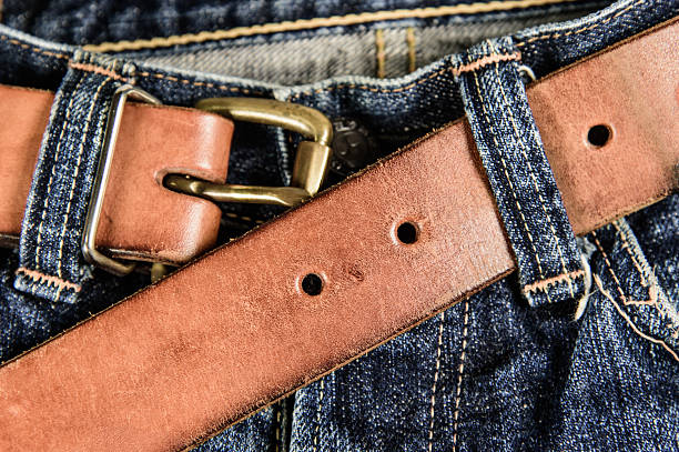 Blue jeans with old brown belt in retro color stock photo