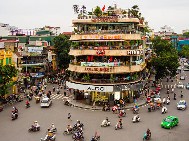 Traffic in Hanoi, Vietnam View of the traffic in Hanoi, Vietnam in front of the City View Cafe building on a gloomy afternoon. hanoi stock pictures, royalty-free photos & images