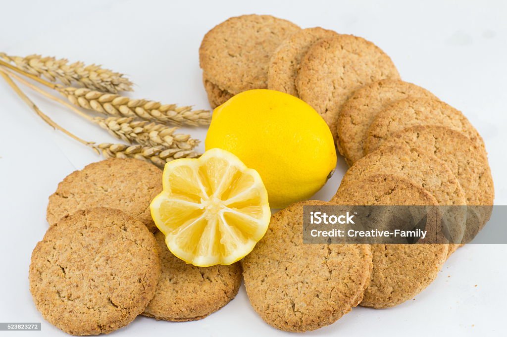 Integral biscuits with lemon on white background Integral biscuits decorated with lemon on white background Backgrounds Stock Photo