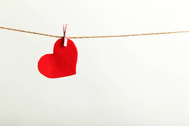 istock Love heart hanging on rope on a white background 523823960