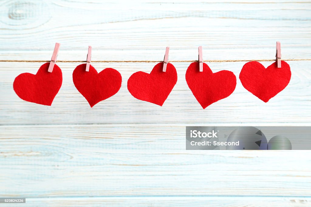 Love hearts hanging on rope on a blue wooden background Beauty Stock Photo