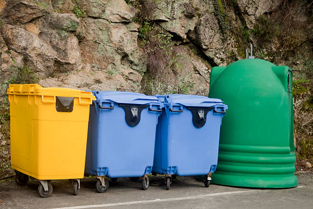 istock Green, blue and yellow garbage bins for recycling. 523824808