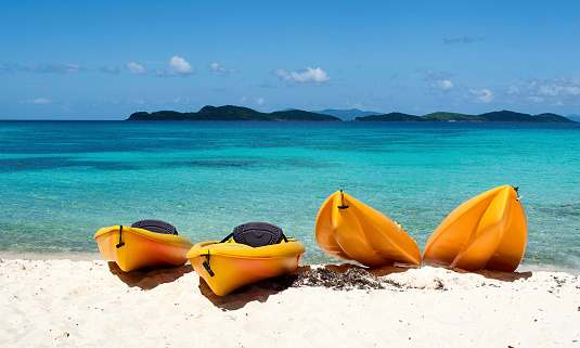 Four yellow canoes on the beach, St Thomas, US. Virgin Islands