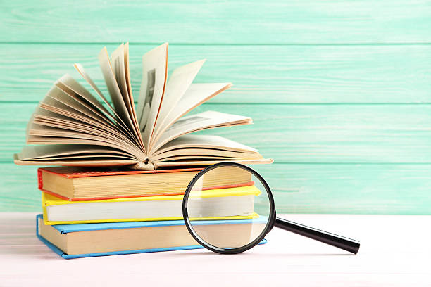 istock Magnifying glass on a pink wooden table 523825956