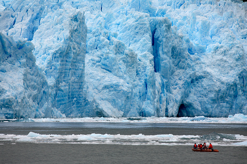 Adventure Tourism. Tourists in a zodiac view the terminus of the San Rafael Glacier in Patagonia in southern Chile in South America.