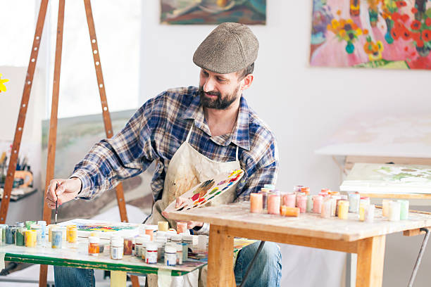istock Fine artist painting at his workshop 523827248