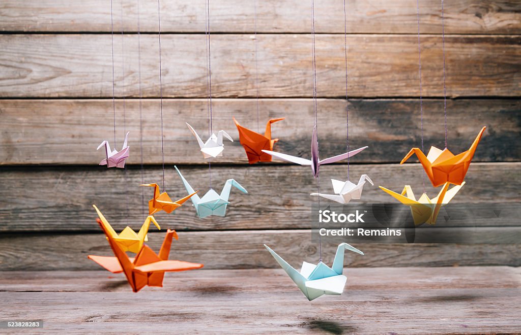 Paper cranes Colorful origami paper cranes on wooden background Paper Crane Stock Photo