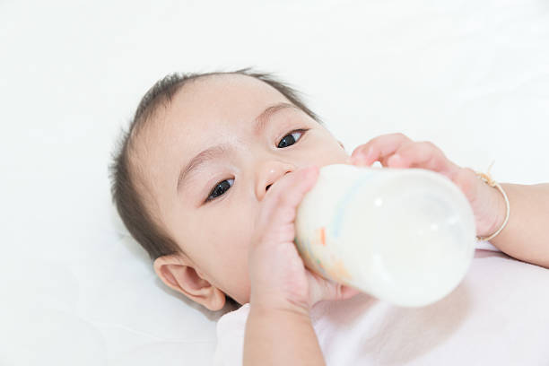 istock Asian baby infant eating milk from bottle 523829455