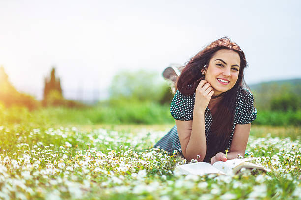 istock young woman lying on meadow 523829716