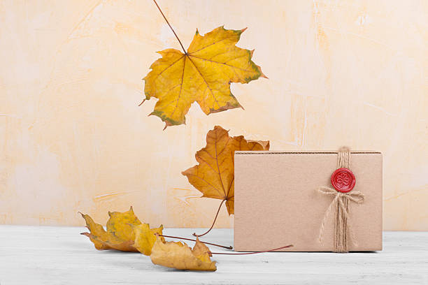 istock Handcrafted gift box with an autumn leaves on background 523830047