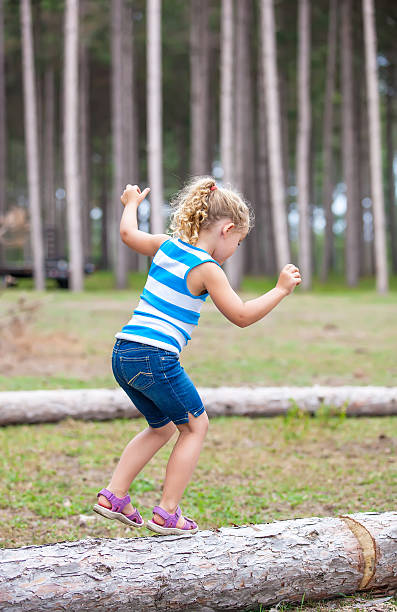 istock Girl Walking on Log 523830633