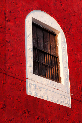 Window in the colonial town in Merida, Mexico. All of the houses here are colorful in the biggest city of the Yucatan peninsula.