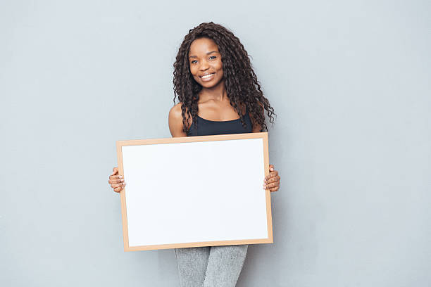 istock Happy afro american woman showing blank board 523831400