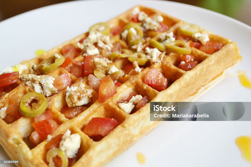 Belgian waffle with tomatoes, cheese and olives Backgrounds Stock Photo