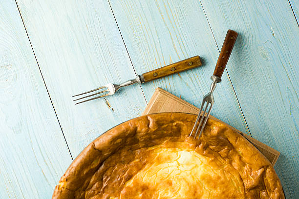 istock Cheese cake and two forks on blue 523832744