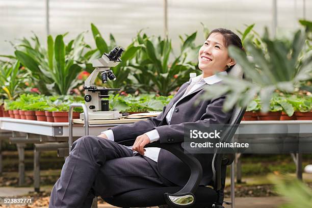 Asian Businesswoman In Greenhouse Stock Photo - Download Image Now - 20-29 Years, Adult, Adults Only