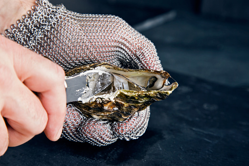 Opening oyster with knife