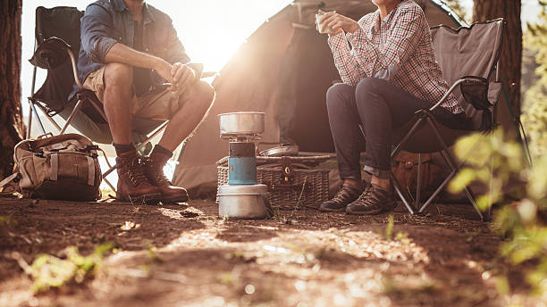 casal sentado em cadeiras fora da tenda - forest sitting men comfortable imagens e fotografias de stock