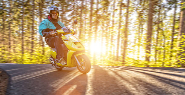 istock Young man driving scooter, blur motion 523861650