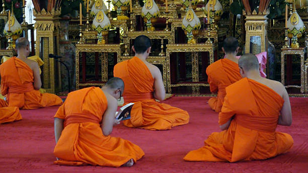 буддийские монахи моля�сь вечером в ват saket. бангкок, таиланд - buddhism monk book zen like стоковые фото и изображения