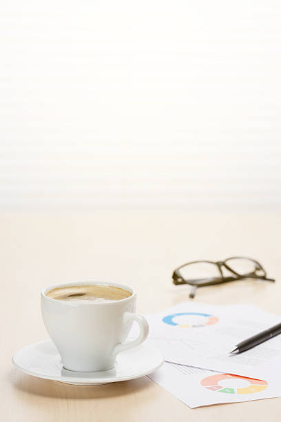 istock Office workplace with coffee, supplies and reports 523863516