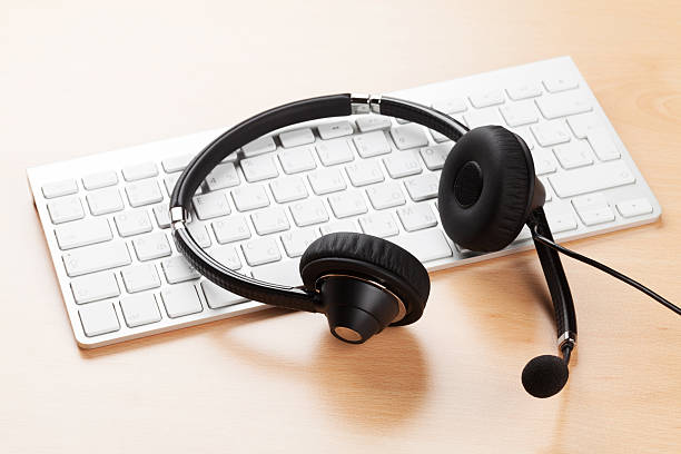 istock Office desk with headset and keyboard 523863944