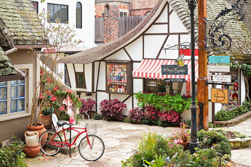 Carmel by the Sea, USA - January 2, 2016: A streetscape in Carmel-by-the-Sea featuring a retail shop housed in a typical  fairytale cottage - style architecture. Carmel located on the Monterey Peninsula was founded in 1902 and is known for its natural scenery and artistic history.