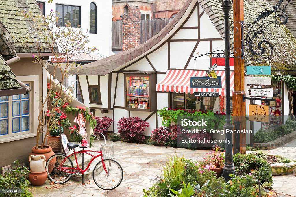 Carmel Street Scene Carmel by the Sea, USA - January 2, 2016: A streetscape in Carmel-by-the-Sea featuring a retail shop housed in a typical  fairytale cottage - style architecture. Carmel located on the Monterey Peninsula was founded in 1902 and is known for its natural scenery and artistic history. Carmel - California Stock Photo