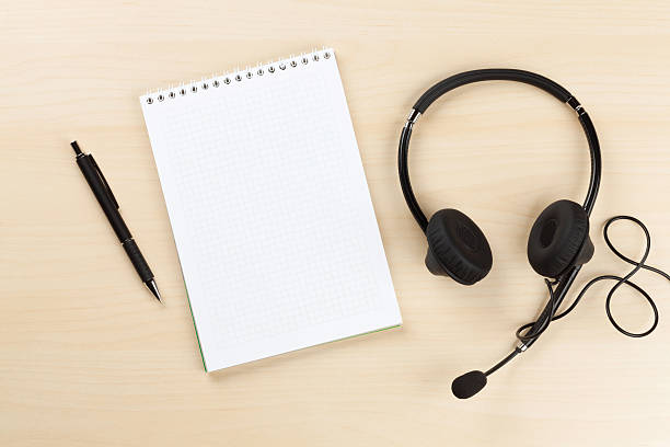 istock Office desk with headset and supplies 523864054