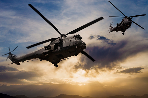 U.K. Airforce  Puma Military helicopters flying over  Kabul City at sunset, Afghanistan.
