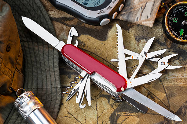 Swiss Army Style Knife - Great Outdoors A Swiss Army style of mulitool knife and equipment for the great outdoors. box cutter knife stock pictures, royalty-free photos & images