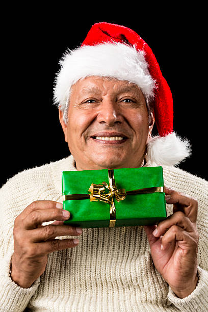 istock Smiling Old Man Handing Over A Wrapped Green Gift 523870695