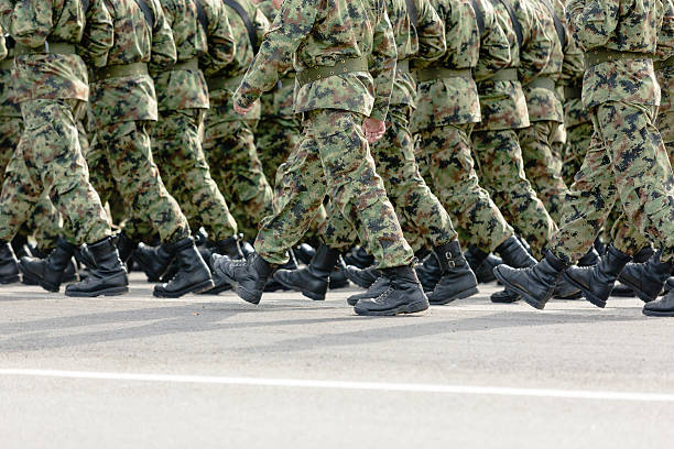 Soldiers marching Unrecognizable soldiers marching in camouflage uniforms, copy space national guard stock pictures, royalty-free photos & images