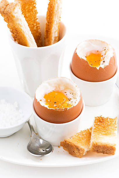 istock boiled eggs and crispy toast for breakfast, closeup vertical 523871728