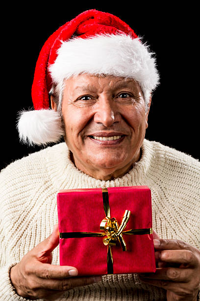 istock Aged Man With Santa Claus Cap and Red Xmas Gift 523871883