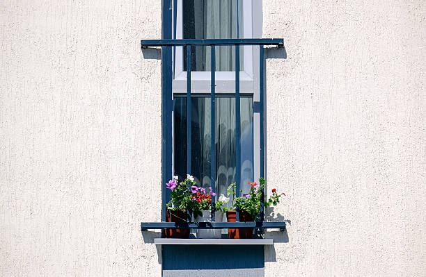 istock French Balcony with flowers in the white house 523871948
