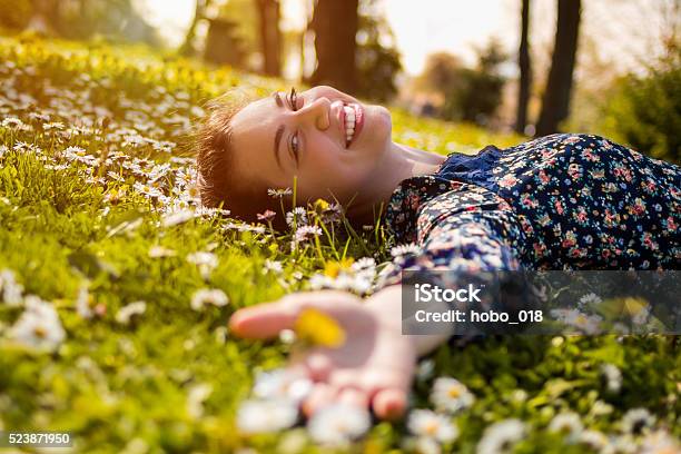 Pretty Young Teenage Girl Relaxing On A Grass Stock Photo - Download Image Now - Springtime, People, Happiness