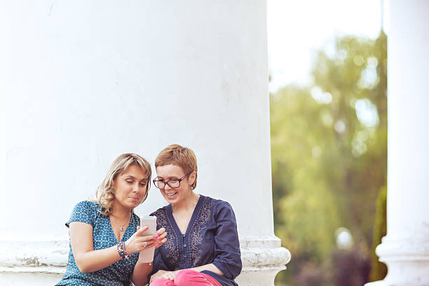 istock Two mature women checking the smart phone together 523871963