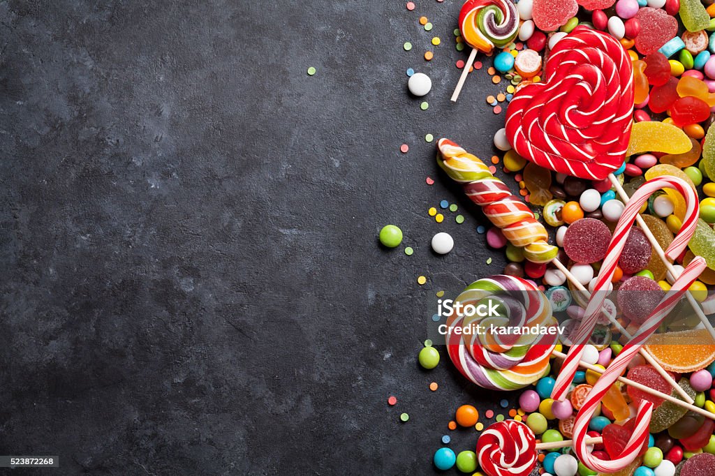 Colorful candies, jelly and marmalade over stone Colorful candies, jelly and marmalade over stone background. Top view with copy space Candy Stock Photo