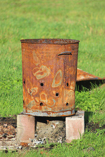 istock Image of rusty garden waste incinerator bin, on lawn grass 523872363