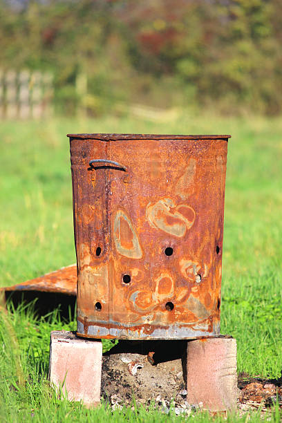 istock Image of rusty garden waste incinerator bin, on lawn grass 523872365